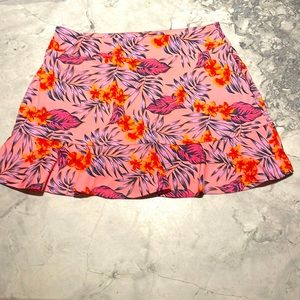 Tommy Bahama Golf Skort. NWOT. Beautiful pink/coral color with floral design.